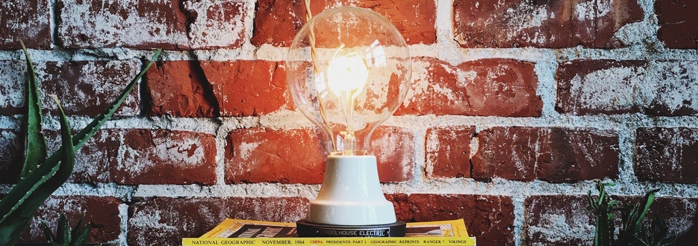 lightbulb against a brick wall